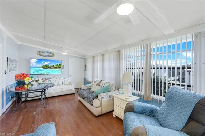 Living room featuring ceiling fan and hardwood / wood-style flooring