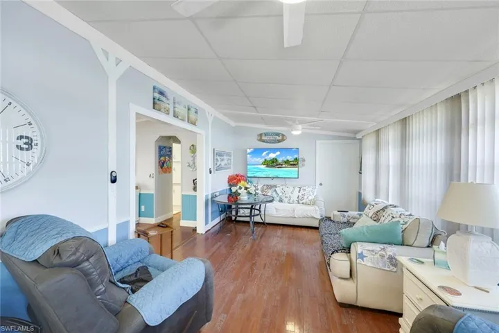 Living room with hardwood / wood-style floors and ceiling fan