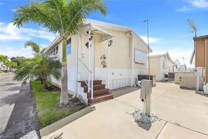 Rear entry. Showing cooling unit and a patio
