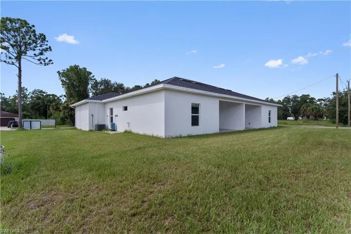 View of home's exterior featuring a yard and stucco siding