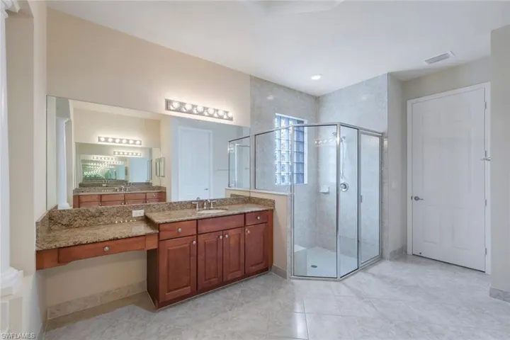 Master bathroom with his & her granite countertop vanities, shower, tub (not shown), and W/C