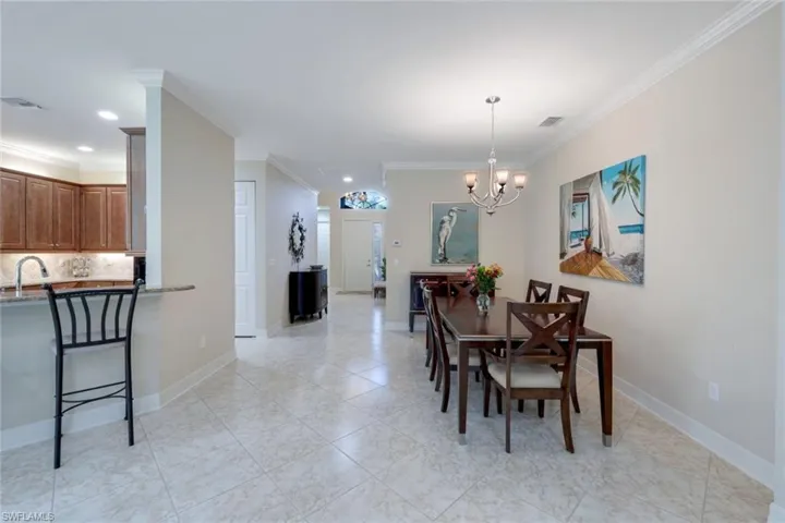 Dining room with tile floors adjacent to the kitchen area.