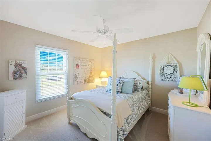 Carpeted bedroom with ceiling fan