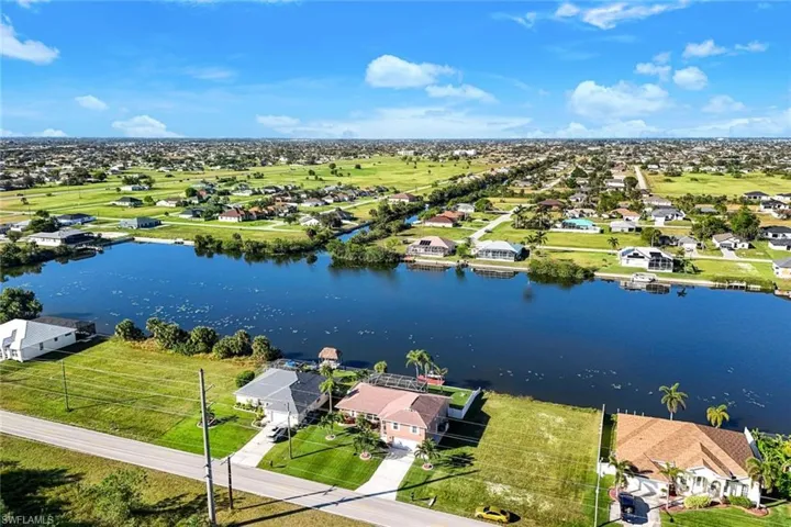 Birds eye view of property with a water view