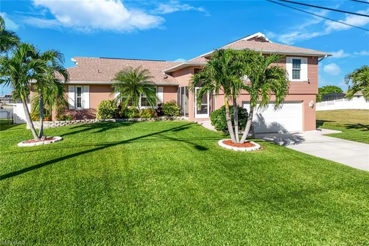 View of front of home featuring a front yard and a garage