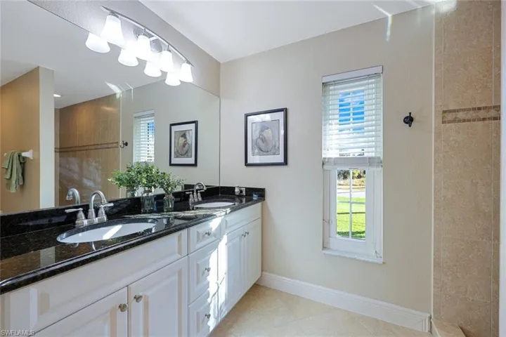 Bathroom with vanity and tile patterned floors
