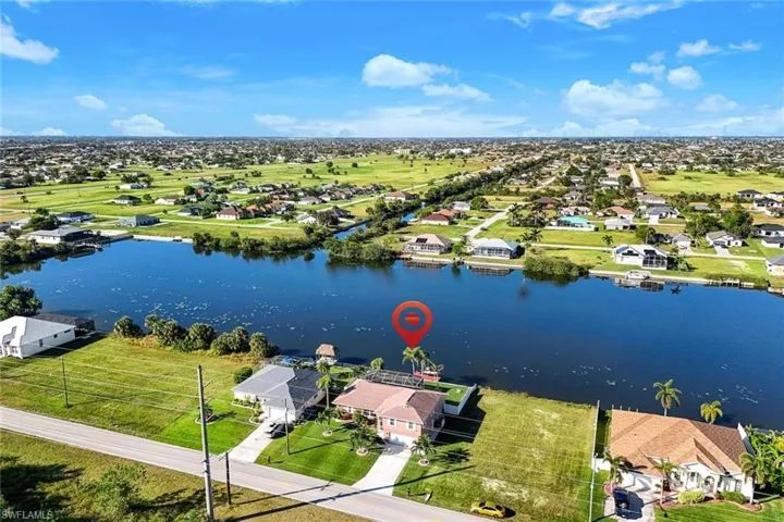 Birds eye view of property with a water view
