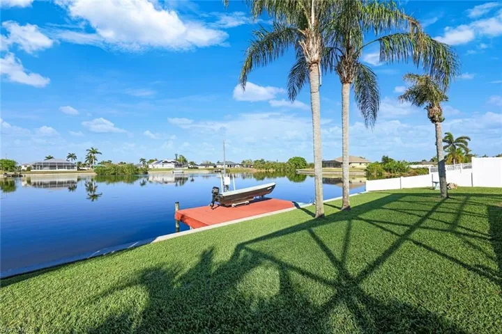 Dock area featuring a water view and a yard
