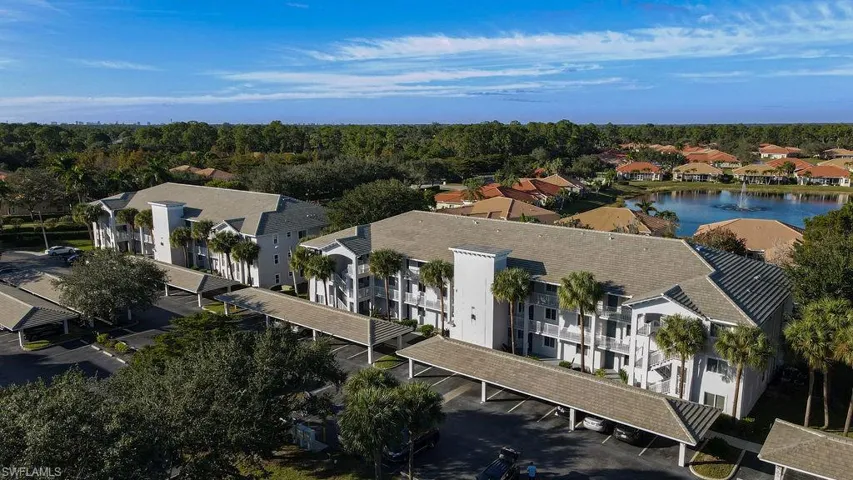 Drone / aerial view of a large body of water and apartment complex / building