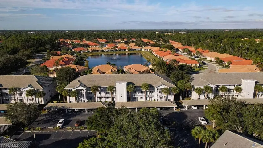 Aerial perspective of suburban area featuring a nearby body of water