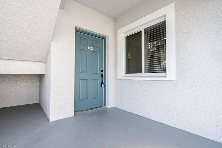 Property entrance featuring stucco siding