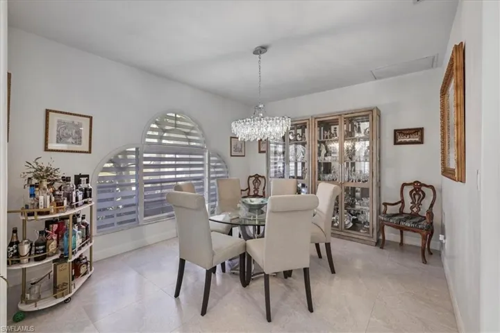 Dining space featuring a chandelier and baseboards