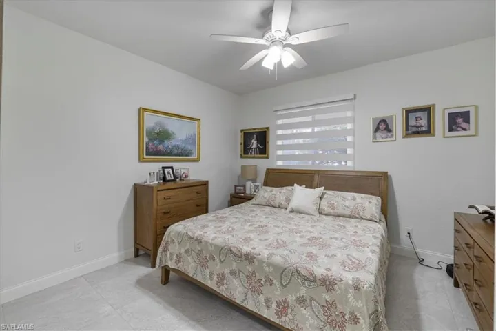 Bedroom featuring ceiling fan and baseboards