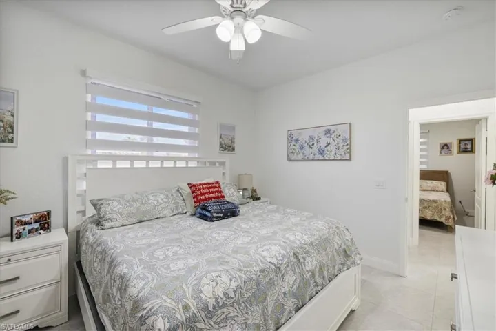 Bedroom featuring ceiling fan and light tile patterned flooring