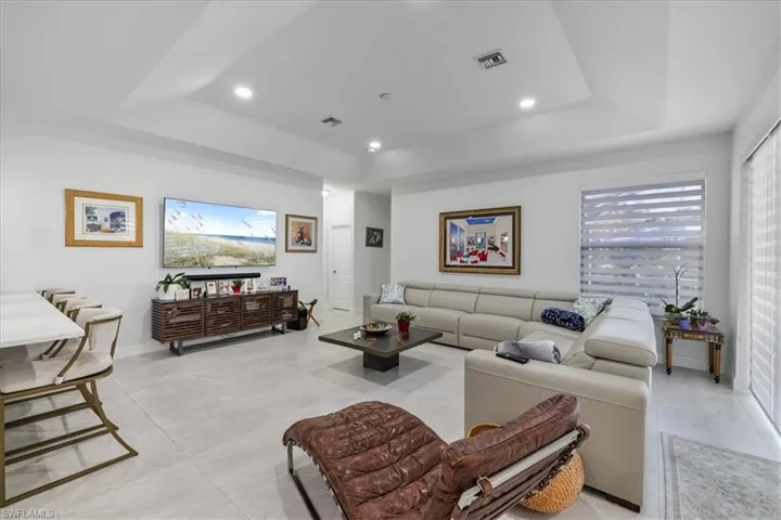 Living area with a raised ceiling and recessed lighting