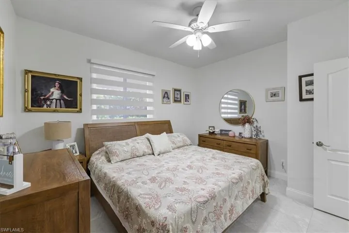 Bedroom featuring a ceiling fan and baseboards