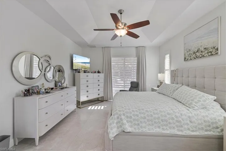 Bedroom with a ceiling fan and light tile patterned floors
