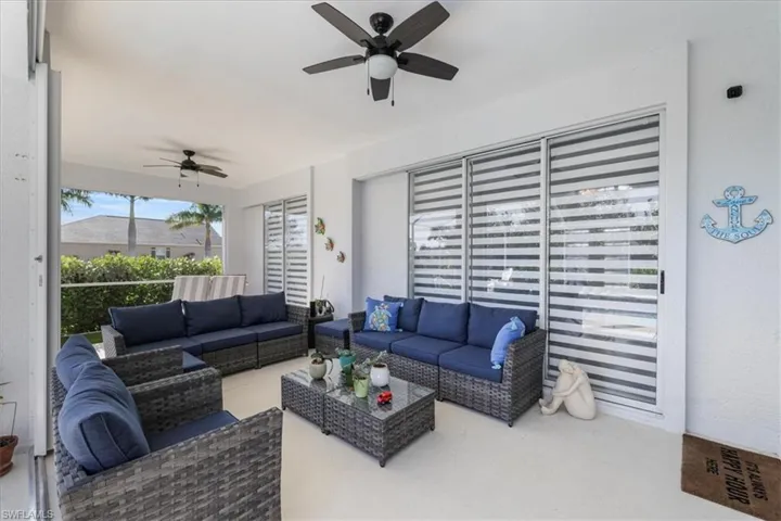 Living room featuring a ceiling fan and finished concrete flooring