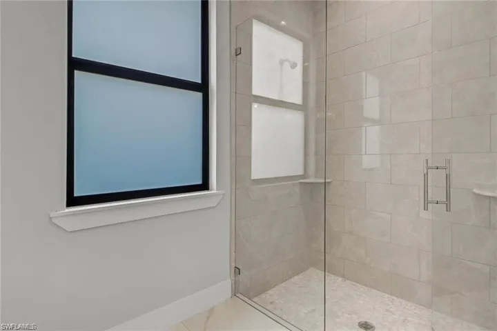 Bathroom featuring a shower with door