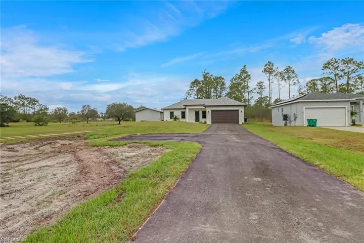 Ranch-style home featuring a front lawn