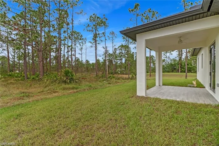 View of yard featuring ceiling fan and a patio area