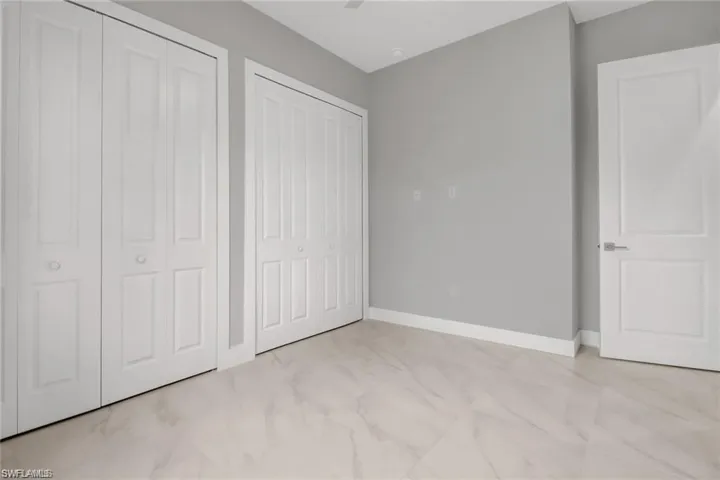 Unfurnished bedroom with two closets