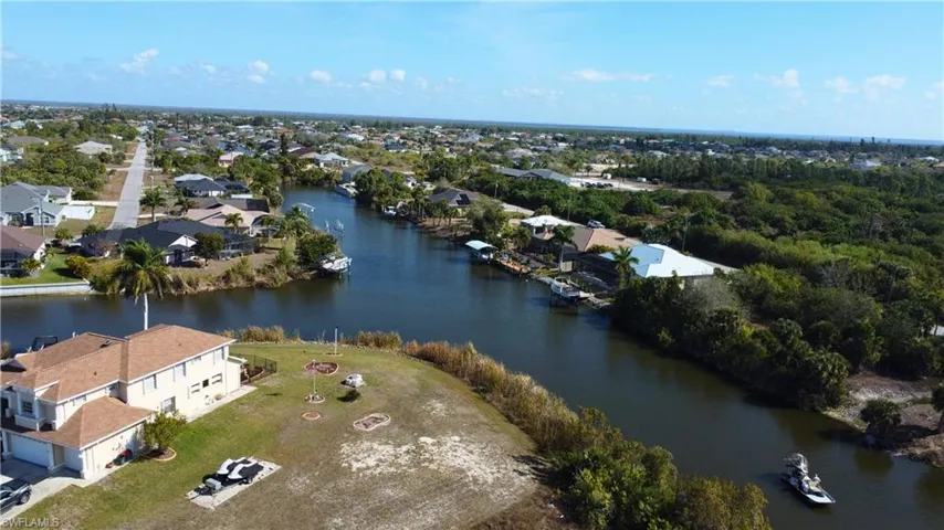 View of property location with a nearby body of water and nearby suburban area