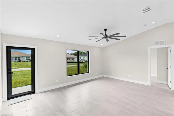 Living room featuring vaulted ceiling, recessed lighting, and a ceiling fan