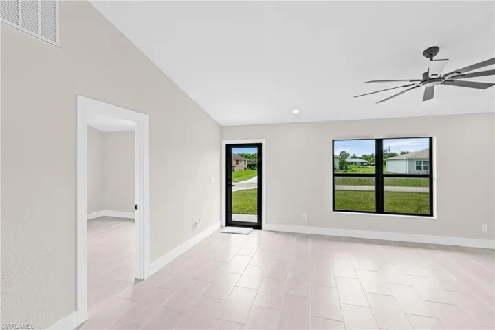 Living room featuring ceiling fan, vaulted ceiling, and recessed lighting