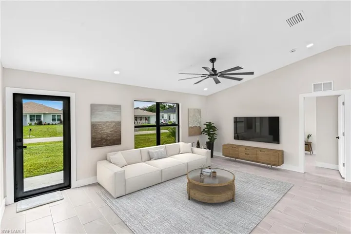 Virtually Staged -Living room featuring lofted ceiling, ceiling fan, and recessed lighting