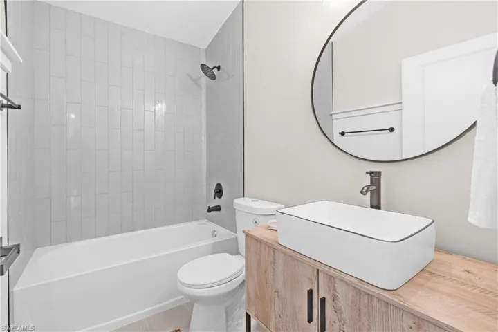 Bathroom featuring  shower combination and vanity