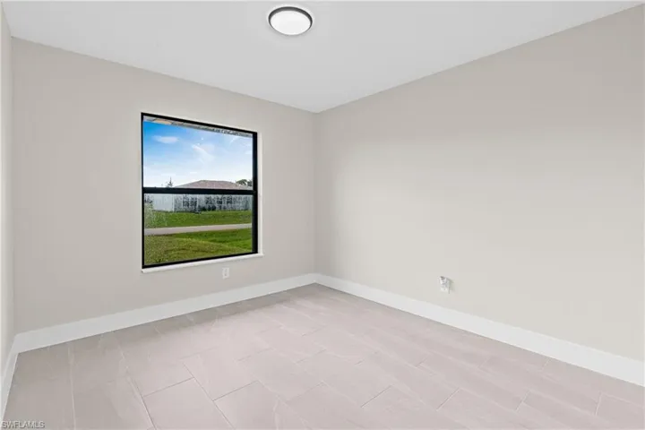 Spare room featuring baseboards
