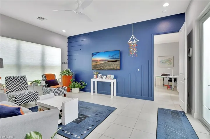 Tiled living room featuring ceiling fan