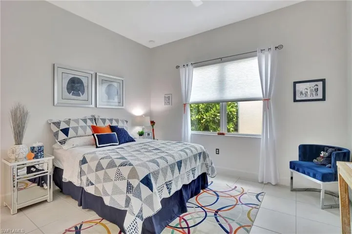 View of second tiled floor bedroom with walk in closet
