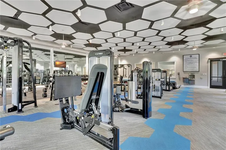 Exercise room with carpet flooring and ceiling fan