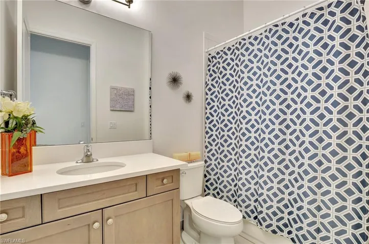 Second en suite Bathroom featuring toilet and vanity