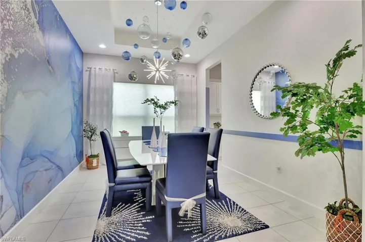 Formal Dining room featuring light tile floors and a raised ceiling/Feature Wall