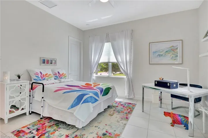 Third tiled bedroom with ceiling fan, walk in custom built closet