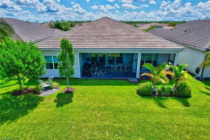 Back of property with a yard