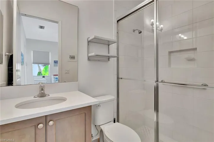 Third en suite Bathroom featuring an enclosed shower, vanity, and toilet