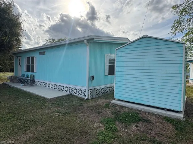 View of side of property featuring a yard