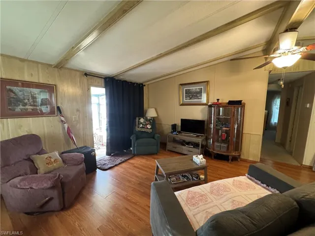 Living area with wood walls and wood finished floors