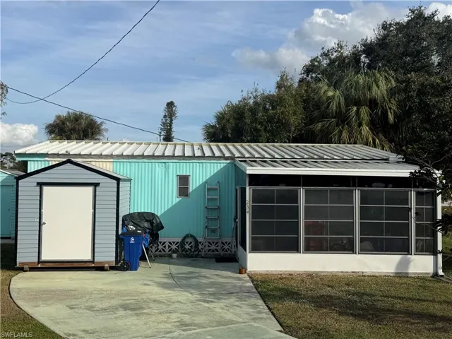Garage featuring a storage shed