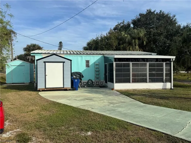 View of shed featuring a sunroom
