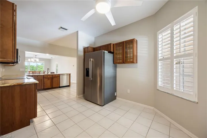 Well appointed Kitchen with loads of storage incl.: corner lazy susan, slide outs, tall pantry. Slide-in induction glass cooktop w/ Convection Oven & Microwave. View from the Breakfast nook area of Kitchen towards main kitchen and open living space. Refrigerator~NEW 2025! LG Side by Side 26.6 CuFt.