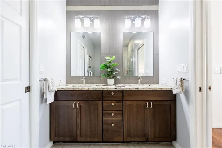 Fully renovated Bathroom featuring double vanity, double mirrors, upgraded vanity and more.