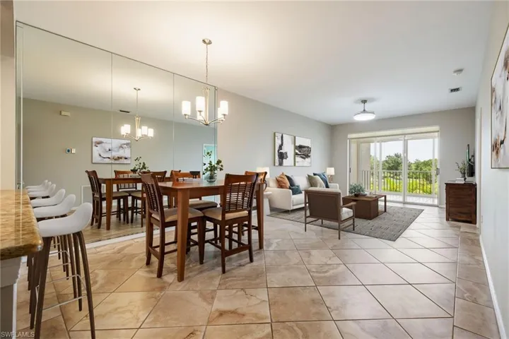 Open Floor plan with combo Dining / Living featuring large sliding glass doors that open to gorgeous golf course views. Upgraded Tile flooring. Note: virtually staged photo