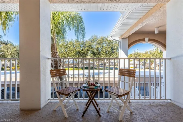 View of Front Condo walkway-notice protected/roof coverage of entrance and stairs to 2nd floor.