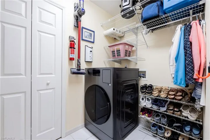 Laundry,  storage room, "Mechanicals closet". NEW Samsung Bespoke Ventless  Washer / Dryer combo. ($2000 value) Extra shelving added for storage flexibility. Closet hosts AC and H20 tank.