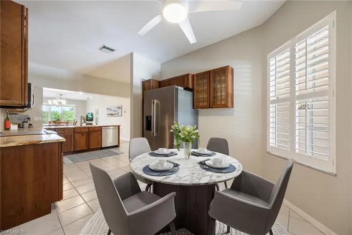 Well appointed Kitchen with loads of storage incl.: corner lazy susan, slide outs, tall pantry. Slide-in induction glass cooktop w/ Convection Oven & Microwave. View from the Breakfast nook area of Kitchen towards main kitchen and open living space. Refrigerator~NEW 2025! LG Side by Side 26.6 CuFt. Note:Virtually staged photo